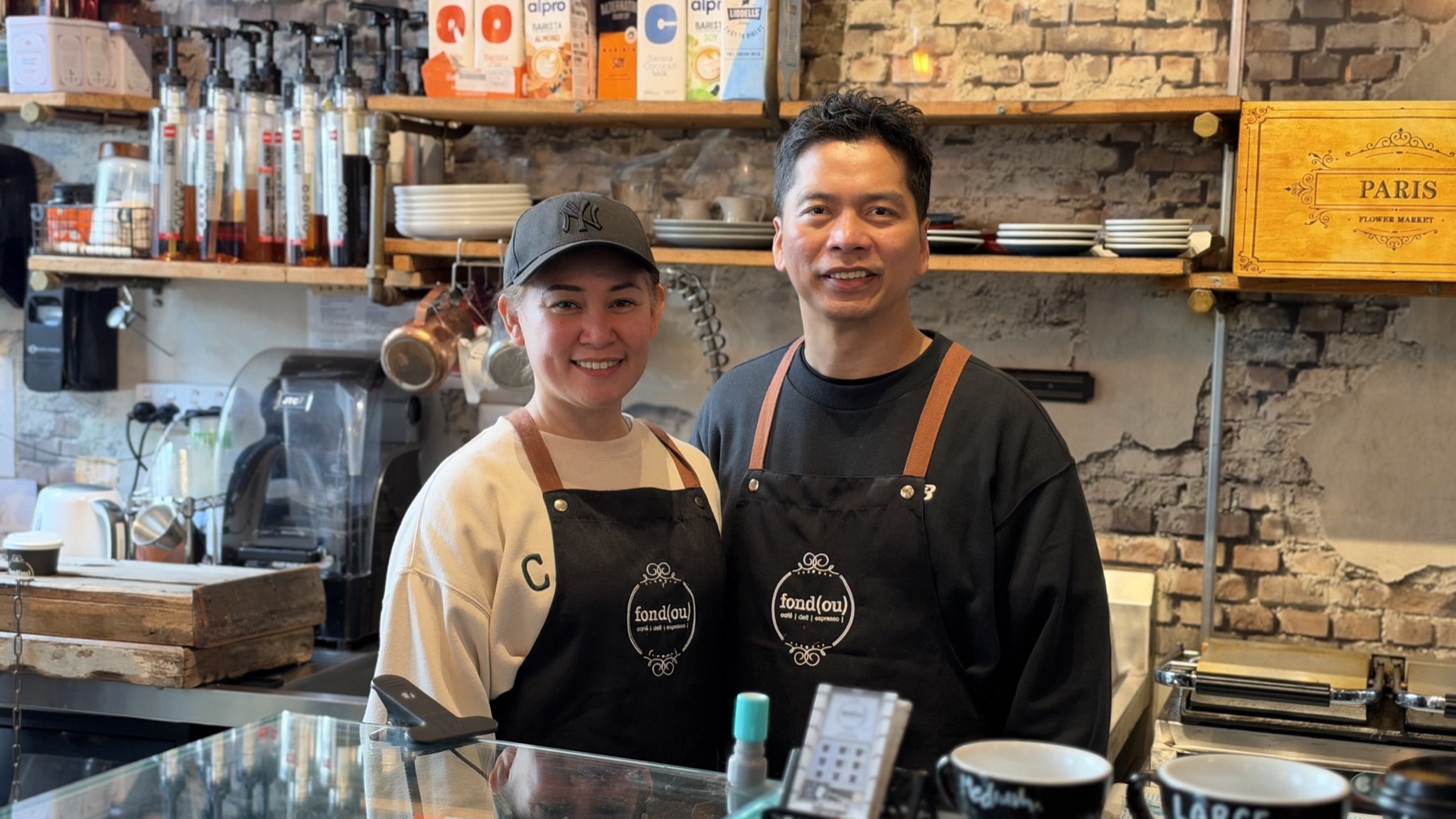 Jerry and his wife behind the counter at Fondou Cafe in Auckland