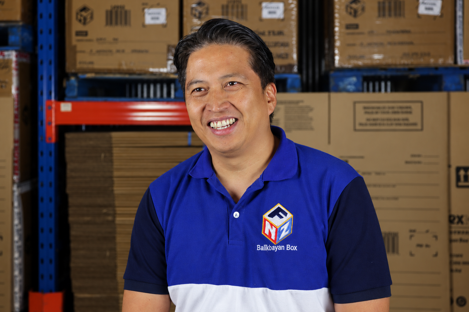 Harold Manuyag of ForexNZ surrounded by balikbayan boxes